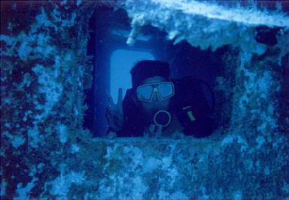 Tom through wreck porthole